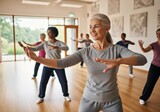 Group of mature adults practicing Tai Chi in a bright, airy studio