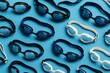 © Pixels Hunter - Swimming goggles in various colors arranged in a neat pattern on light blue background, showcasing abstract symmetry and repetition concept. Ai generative