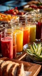 © ABF_MATEO - Bright and refreshing fruit and vegetable juices in tall glasses, accompanied by bread and cucumber slices, showcasing a healthy spread.