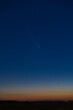© badescu - Spectacular Celestial Phenomenon: The Rare Comet ATLAS 2024 Visible Against a Deep Red Post-Sunset Sky During Astronomical Twilight
