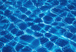 © DesignSells - Crystal clear blue water surface with shimmering light ripples and gentle waves, close up view highlighting reflections, depth, motion, and tranquil summer pool ambiance