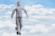 © Ljupco Smokovski - Man in pajamas jumping in the sky