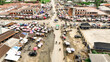 © AmazingAerialAgency - Aerial view of bustling market streets teeming with life, where vibrant umbrellas dot the landscape amidst the buildings, Eleme, Rivers, Nigeria.