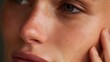 © fotofabrika - Close-up of a woman's face showing natural skin details and subtle expressions during daytime