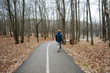 © Aleksey - man strolls with canine nearby, individual and pet enjoy reflective walk along tranquil forest pathway