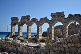 Ruins of an old industrial building made of stone, located by the Aegean Sea in Samos, Greece. Historical coastal architecture and abandoned structure concept.
