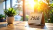 © faiz_99 - Close-up of 2026 desk calendar on wooden table with soft light and clean workspace. Perfect concept for planning, schedule, or time management design.