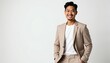 © miss irine - Asian man smiles, wears jacket suit, tee shirt on white backdrop. Confident businessman poses in formal wear, expresses optimism. Professional model looks stylish, presents company leadership in