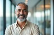 © miss irine - Mature bearded businessman portrait. Happy smiling male senior in modern office. Attractive grey haired entrepreneur looks at camera. Pro executive boss poses indoors at workplace. Leadership,
