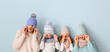 © Pixel-Shot - Happy family in winter clothes on color background