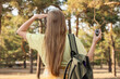 © Pixel-Shot - Female traveler with compass and backpack in forest, back view