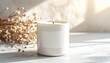 © Nurita - Minimalist white scented candle with a blank label, casting a warm glow and creating a serene, cozy atmosphere, perfect for home decor and relaxation next to dried botanicals