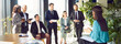 © Studio Romantic - Businesswoman conducting a work conference or meeting for a team of colleagues in an office. The group of people is engaged in productive conversation, showing effective teamwork and collaboration.