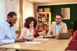 © bnenin - Young Couple Consults Insurance Agent During Home Real Estate Meeting at Modern Living Room