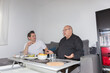 © Beti Argi - Two adult men chatting in the living room while having lunch. Bright and realistic domestic atmosphere, horizontal with copy space. Concept of friendship and home life