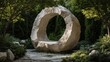 © nameera_hasan - circular stone sculpture in green garden