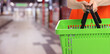 © New Africa - Customer holding empty shopping basket at supermarket, closeup. Banner design