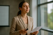 © thodonal - Young businesswoman preparing for presentation with document in hand