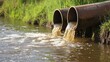 © Alokesh - Industrial discharge pipes polluting river high resolution photo