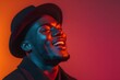© Maryna - Man with a black hat and a big smile on his face. He is wearing a black jacket and a black hat