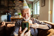 © Geber86 - Senior man happily celebrating birthday on video call at home