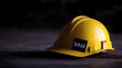 © photo for everything - A bright yellow safety helmet with a sticker labeled 'SALE' resting on a textured surface against a stark black background, conveying a sense of safety at a reduced price.