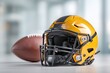 © whitestorm - Close-up shot capturing a yellow and black American football helmet beside the ball, symbolizing the spirit and excitement of the game.