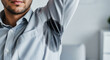 © ATIKUL - Man experiencing excessive underarm sweating, a common symptom of hyperhidrosis, causing visible wet stains on his shirt