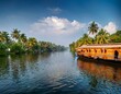 © Karen - serene backwaters of kerala a tranquil journey amidst lush greenery and vibrant houseboats
