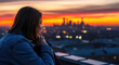 © drimerz - Young Woman Watching City Sunset from Rooftop