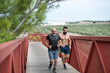© Antonio Recena - A 65-year-old man runs across a pedestrian bridge with his 40-year-old son