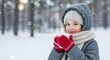 © sambath - A young girl in a winter coat and hat holding a hot drink in a snowy forest.