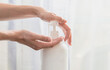 © Maria - Woman hands pushing pump plastic soap bottle on white background