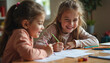 © AlenaSi - Two little sisters are drawing, enjoying children drawing together, creating art side by side. These adorable children drawing and sketching in their living room shows their love for art,