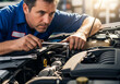 © Laura - Mechanic at work, using a wrench to repair a car engine in a professional garage workshop