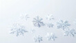© Spike - A collection of white snowflakes scattered on a bright, clean surface, creating a wintery and delicate scene.
