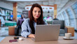 © Andrey Popov - Busy Traveling Businesswoman Typing On Laptop