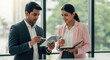 © Shivani - Business Colleagues Collaborating on Tablet and Notebook in Modern Office