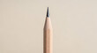 © MdRahat - A close up shot of a sharpened pencil against a plain background with soft lighting and neutral tones
