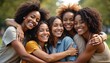 © Viktor - Five happy young adult Black women hug tightly outdoors. Smile broadly, celebrating strong female friendship, community. Diverse group bond represents support, unity, connection among friends in