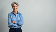 © Viktor - Smiling mature businesswoman posing in studio. Elderly female with arms crossed. Confident woman with grey hair smiles. Pro lady in formal wear. Beautiful adult person.