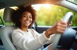 © Viktor - Smiling young African American woman driving car. Female driver with curly hair wearing white sweater. Happy person with toothy smile looking ahead. Woman sitting in automobile with hands on steering