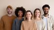 © perfectlab - Diverse group of five smiling young adults standing together against neutral background in casual clothing