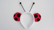 © vxnaghiyev - White headband designed with black antennae and cut-out ears for a ladybug outfit, playful costume accessory