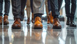 © ezra - Corporate Steps: A group of professionals walks confidently across a reflective surface, showcasing their elegant footwear. Representing a sense of professional purpose.