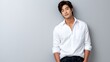 © Natalia - Man poses confidently against a plain background in casual attire