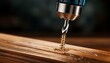 © Kerry - close up of a drill driving a screw into wood