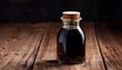 © Ellis - dark liquid in glass bottle with wooden lid on rustic wooden surface