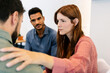© Xavier Lorenzo - Colleagues offering emotional support during group session. People comforting stressed coworker. Mental health and wellbeing concept.