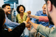 © Xavier Lorenzo - Business team celebrating success with raised fists. Coworkers cheering together during team activity. Motivation and achievement concept.